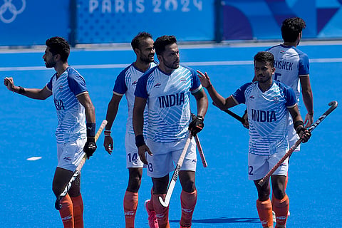 Harmanpreet Singh celebrates with teammates